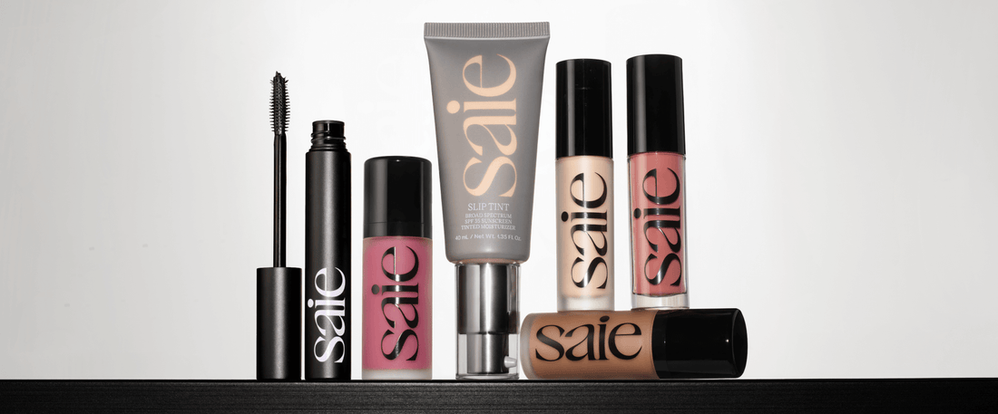 Image of Saie products including the mascara, blush, bronzer, concealer, lip, and foundation